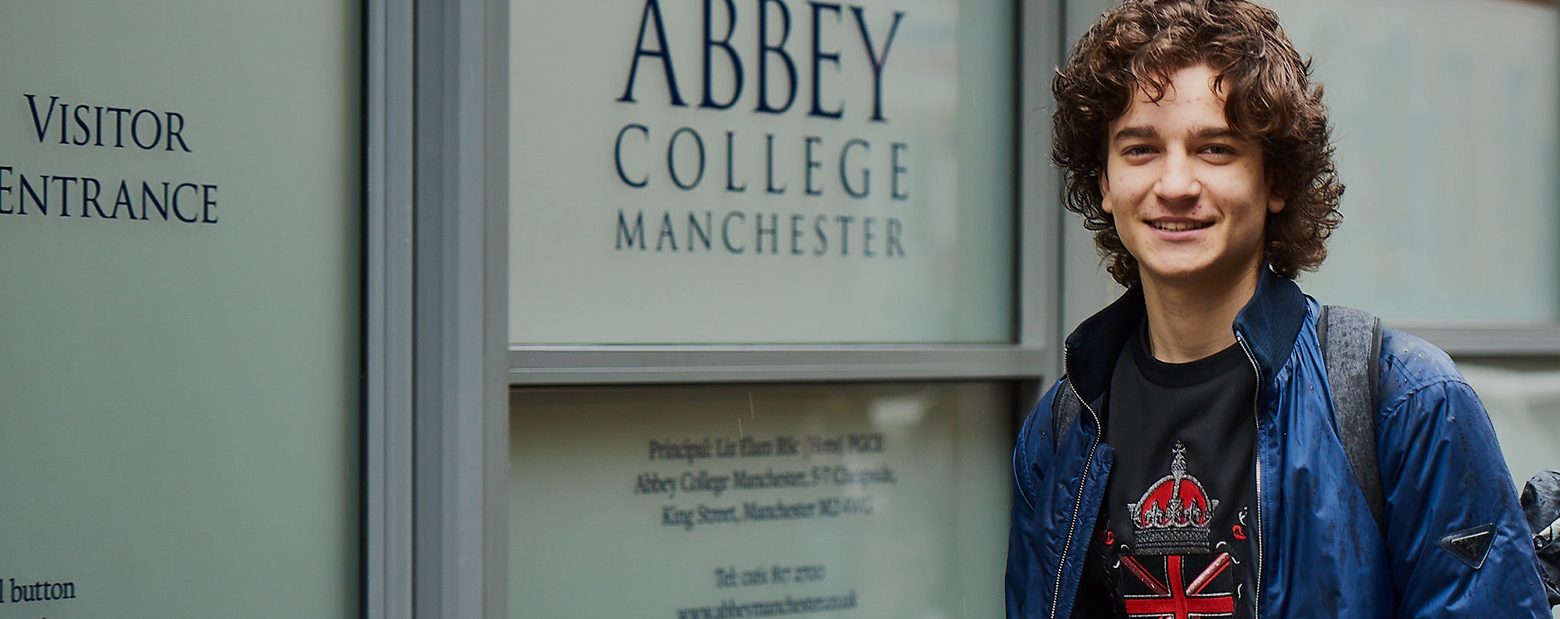Male student standing outside Abbey College Manchester